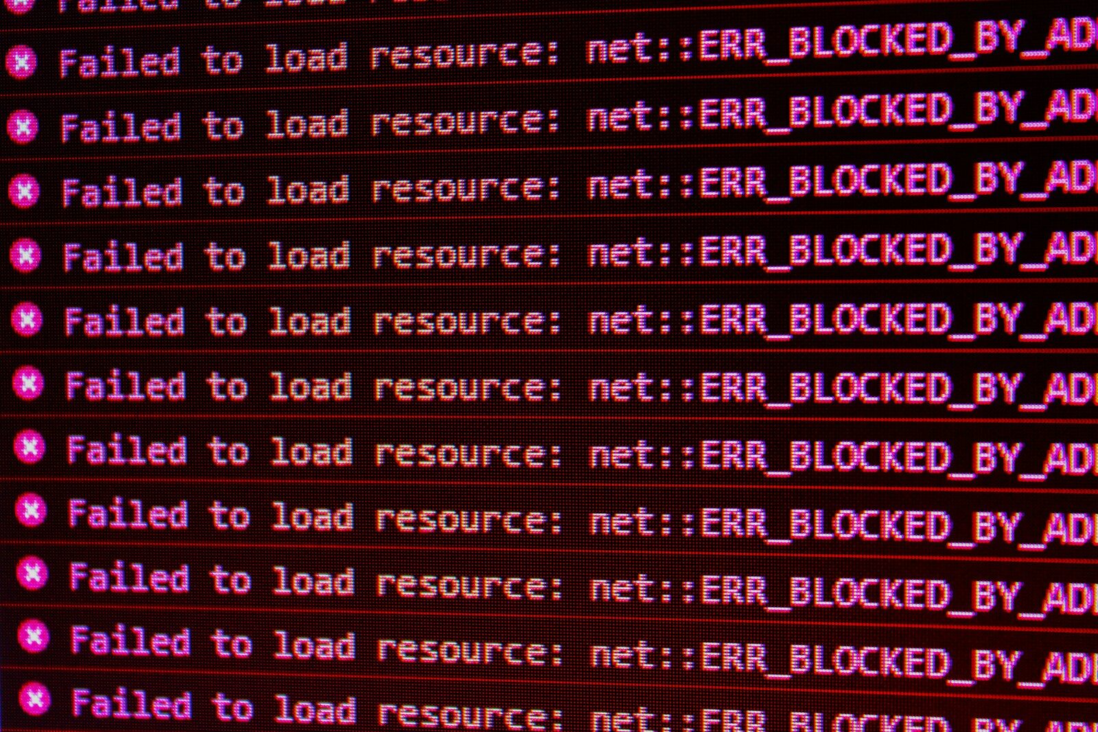 Red error messages on a black computer screen indicating blocked web resources