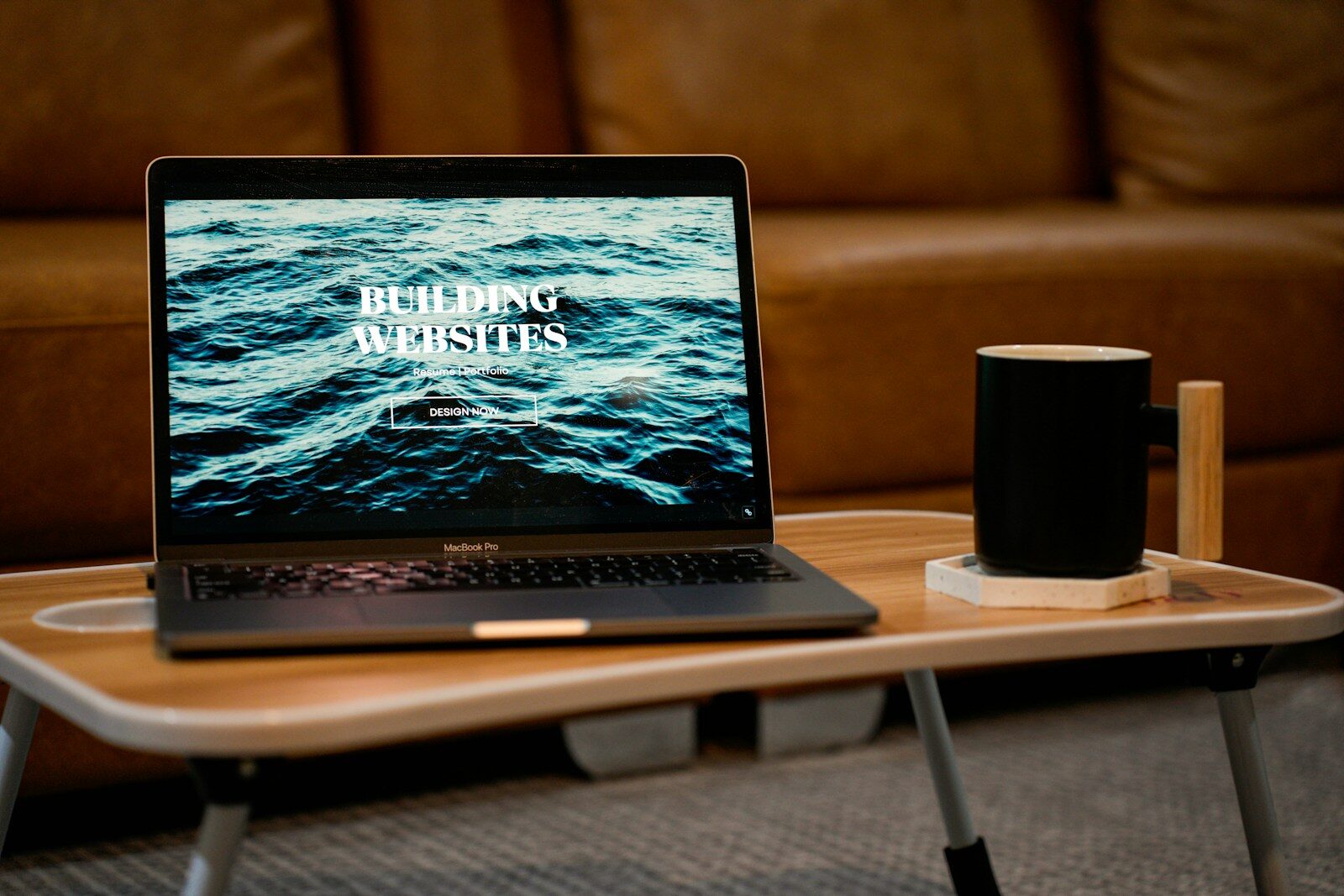 a laptop computer sitting on top of a wooden table